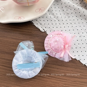 Detail view of pink and blue sequin mini hat hair clips with alligator metal clips