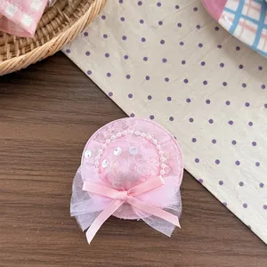 Detailed view of pink lace mini hat headband with sequins and pearl bead accents