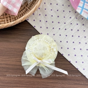 Close-up of cute children's flower hat headband with sequins, pearls, and ribbon bow