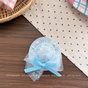 Detailed view of a sweet blue sequin flower mini hat with mesh and pearls