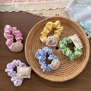 Sweet cartoon plaid hair scrunchies set with cute animal patches in a woven tray