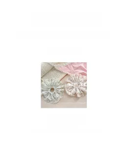 Detail view of pink and blue floral lace hair ties with exact size and weight measurements