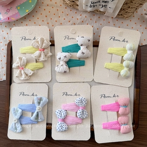Detailed view of handmade polka dot and floral bow hair clips in assorted pastel colors
