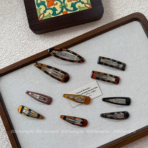 Minimalist tortoiseshell hair clip set in assorted geometric shapes and amber tones