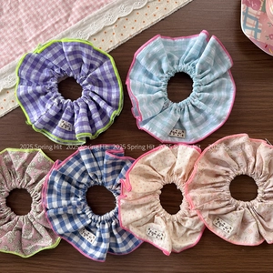 Floral and plaid fabric scrunchie set with colorful overlock stitching and woven label