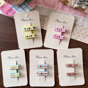 Set di 10 mollette per capelli per bambine con ricami a cuore e tessuto colorato misto