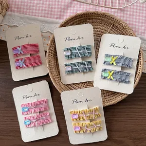 Five sets of Korean style plaid bow hair clips with crystal accents on white cards