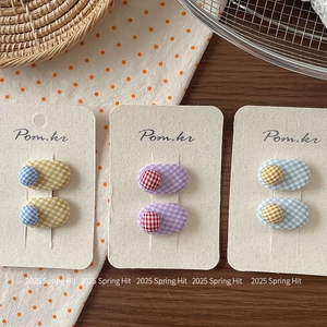 Sweet plaid fabric hair clips in three pastel patterns on a rustic wooden display