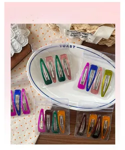 Close-up of colorful candy-colored resin teardrop hair clips in a transparent bag
