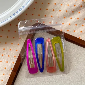 Set of four vibrant teardrop-shaped metal hair clips in high saturation lacquer finish