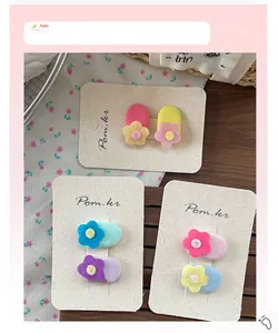 Close-up of sweet oval flower hair clips with felt floral details for kids and girls