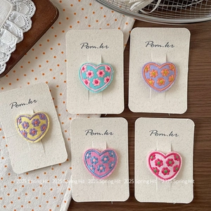 Set of sweet heart-shaped embroidered flower hair clips with decorative fabric textures