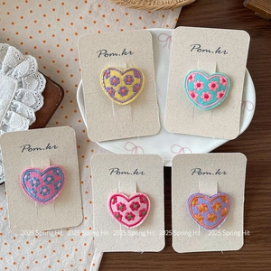 Five-piece set of sweet heart-shaped floral embroidered hair clips on a display card