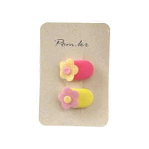 Set of two sweet floral fabric hair clips for girls in pink and yellow colors