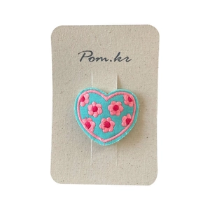 Sweet heart-shaped hair clip with pink floral embroidery on blue fabric base