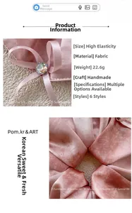 Close-up of pink satin scrunchie with crystal and ribbon bow detail for ponytails