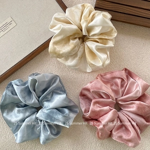 Three-piece satin scrunchie set in gold, blue, and pink colors with silky finish