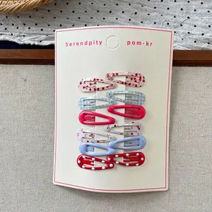 Detailed set of 10 patterned drop-shaped BB hair clips displayed on a white card