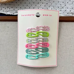 Close-up of 12-piece sweet floral and candy-colored metal water drop hair clips on a card