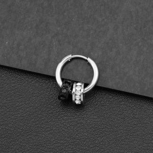 Detail of silver titanium steel earrings with black and white crystal pave circle charms