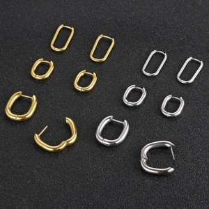 Minimalist U-shaped rectangle hoop earrings in gold and silver finish on black background