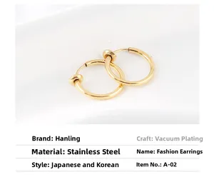Macro shot of gold stainless steel spring clip-on earrings on white silk background