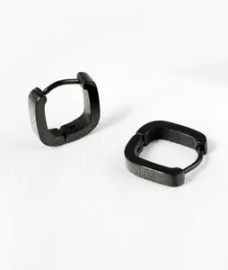 Macro detail of black U-shaped stainless steel square hoop earrings with matte finish
