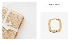Macro shot of U-shaped gold huggie earring with polished finish next to a gift box