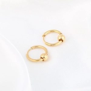 Minimalist gold stainless steel hoop earrings with sliding metal beads on white fabric