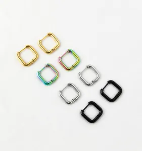 Macro shot of four square stainless steel hoop earrings in gold silver black and rainbow