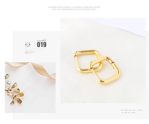 Detail of golden irregular square hoop earrings with polished metal finish and clasp