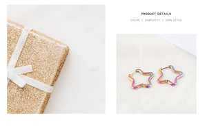 Detail of star-shaped stainless steel earrings with rainbow gradient finish on white silk