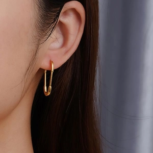 Minimalist gold paperclip safety pin earrings for women with a sleek metallic finish