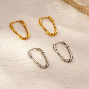 Minimalist paperclip style hoop earrings in gold and silver metal finishes