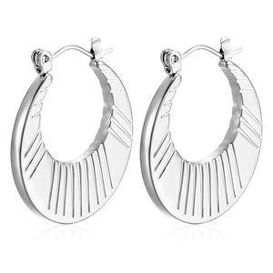 Detail of silver crescent hoop earrings featuring radial textured stripes and pin closure