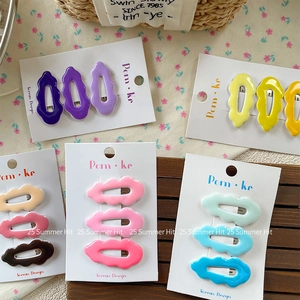 Five sets of colorful wavy hair clips in pastel tones for girls on floral background