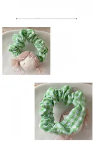 Detail of green plaid scrunchie with cute doll head and 6.7g lightweight design