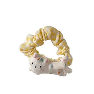 Cute yellow plaid scrunchie with a plush cat doll and embroidery for hair styling