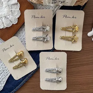 Star and heart shaped hair clips with woven metal texture in gold and silver finish