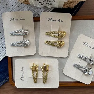 Minimalist heart and star hair clips set in gold and silver with woven texture metal