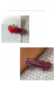Detail showing the 6.5x1.8cm size and reverse side of a handmade strawberry hair clip