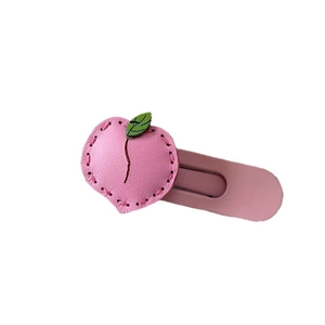 Cute pink peach-shaped leather hair clip for girls with green leaf detail and metal clip