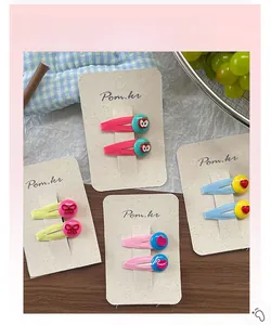 Detail of colorful Korean hair clips for girls featuring cute fruit and bow designs