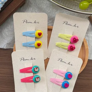 Set of colorful sweet hair clips for girls with cute buttons on wooden tray