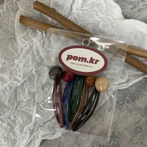 Set of five vintage marble-beaded hair clips in diverse colors shown in packaging