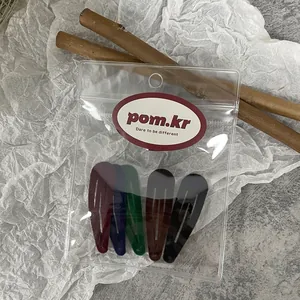 Detailed view of a 5-piece minimalist vintage metal teardrop hair clip set in a zip bag