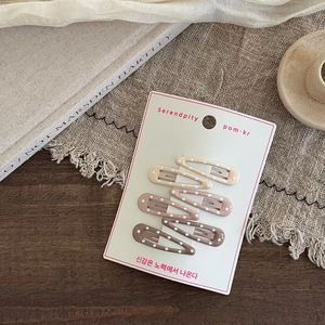 Set of 6 polka dot heart hair clips in gradient earth tones on display card