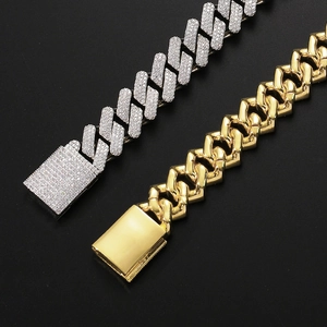 Macro shot of silver zircon-paved and polished gold 20mm Cuban link chains