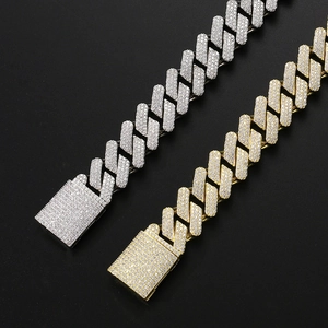 Close-up of gold and silver solid iced out Cuban link bracelets with zircon box clasps