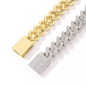 Macro view of 20mm Cuban link bracelet with iced-out zircon pave and polished gold finish